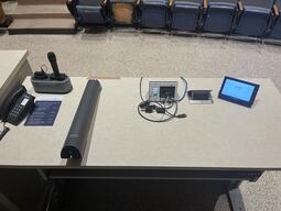 The podium is height adjustable and comes equipped with lecture capture, a document camera as well as a set of microphones.