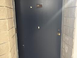 The entrance to the room 210 in Walter Light Hall has a doorknob on the right side of the door.