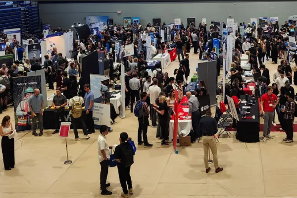 People exploring a series of booths at Career Services Fall Career Fair.