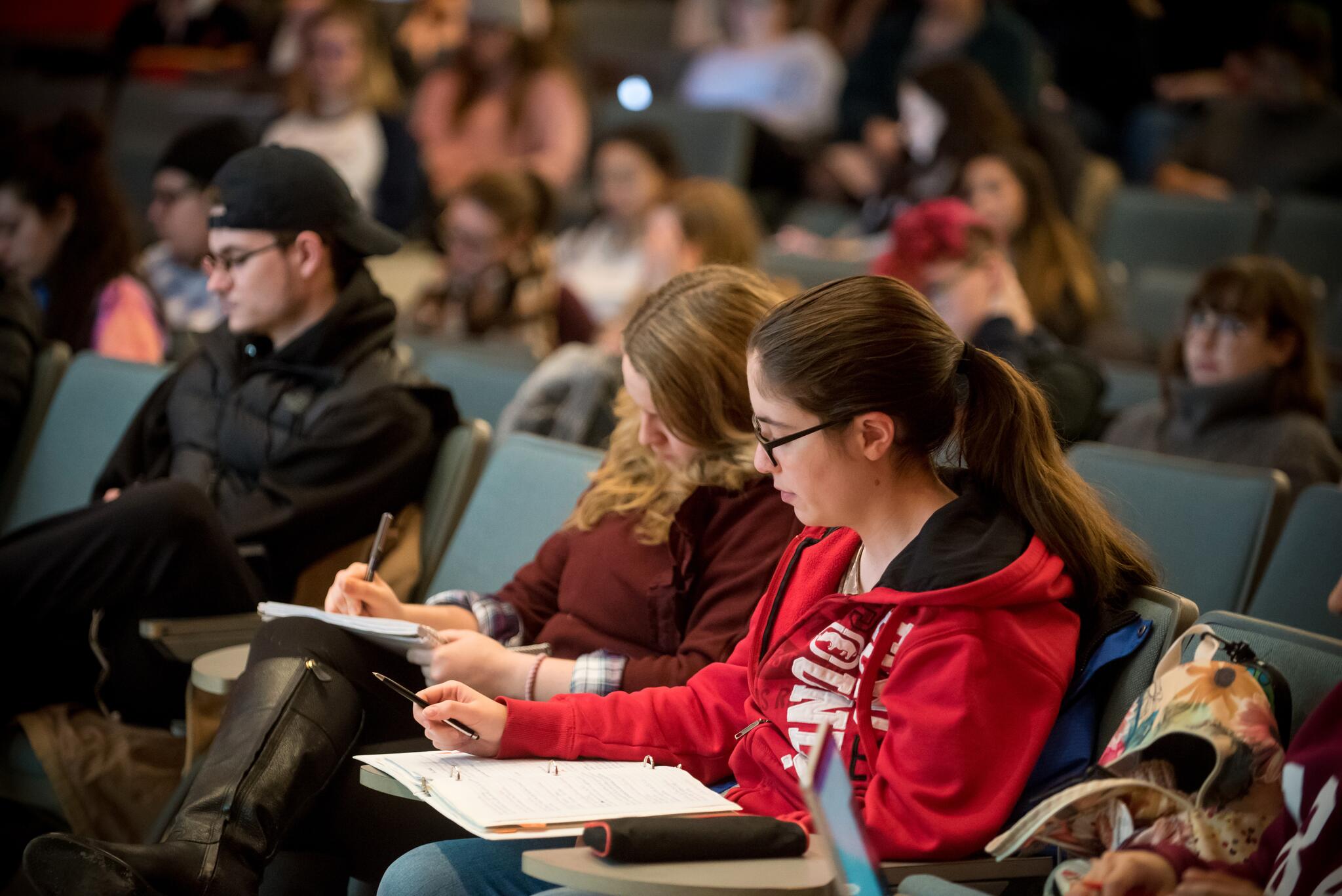 students writing during a lecture