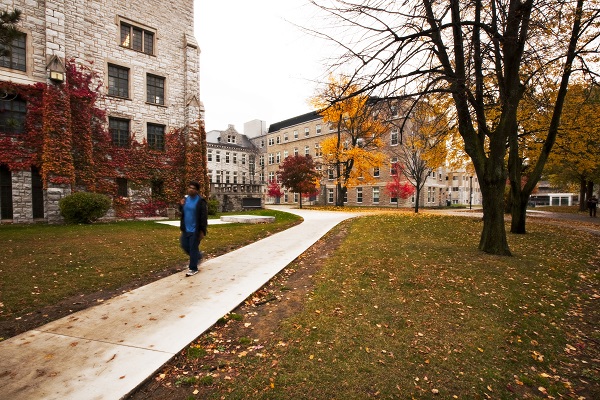 "student walking along a path on campus"