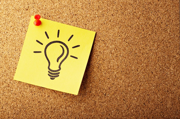 yellow post it with an image of a lightbulb on a corkboard