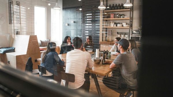 A group of people sitting around a table having a meeting