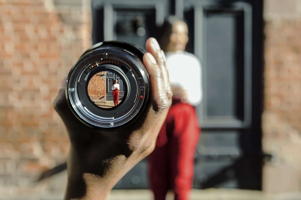 an woman seen through a lens in the foreground 