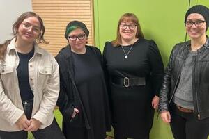 4 CUST students stand in a row