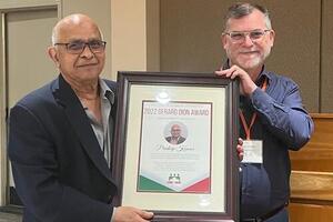 Pradeep receiving award