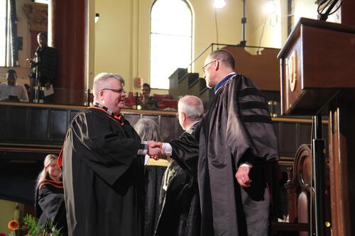 MIR grad walking across stage at ceremony
