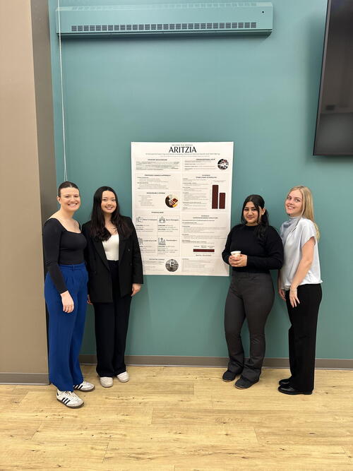 Students standing beside poster