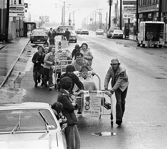 [Padre Laverty in United Way bed race]