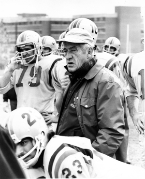 [photo of Frank Tindall on the sidelines at a football game]