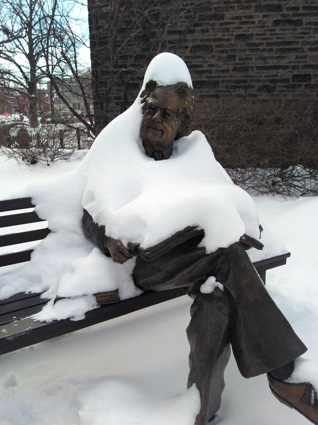 A sitting statue in the snow
