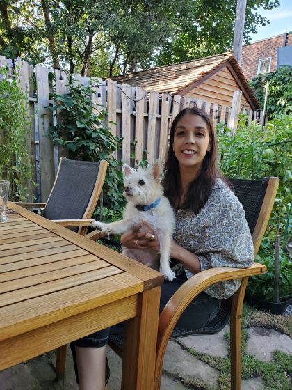 photo of ronjaunee seated with her white dog nickel