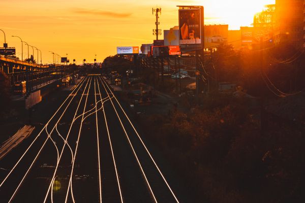 Train tracks, billboard, and sunset