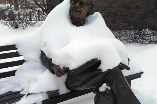 A sitting statue in the snow