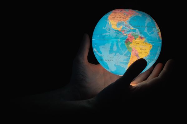 photo of hands holding the globe