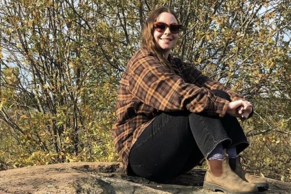 photo of Sara sitting on a rock 
