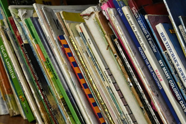 leaning books on a bookshelf