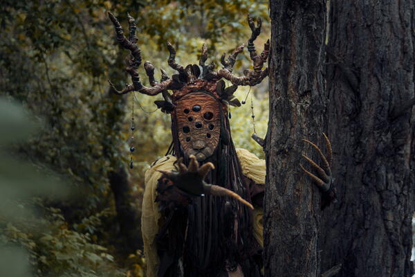 Monster standing behind a tree