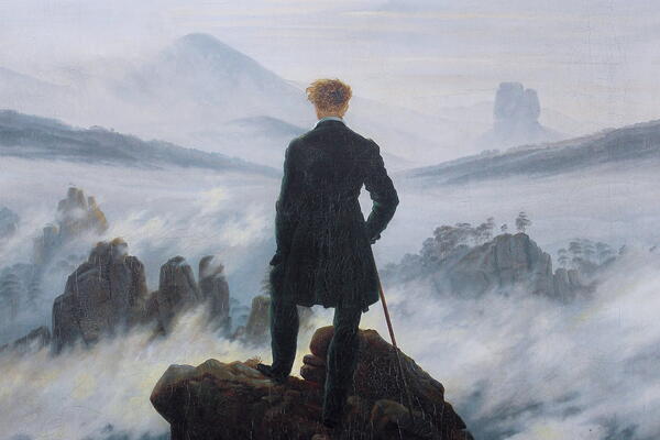 Man looking beyond on a cliff