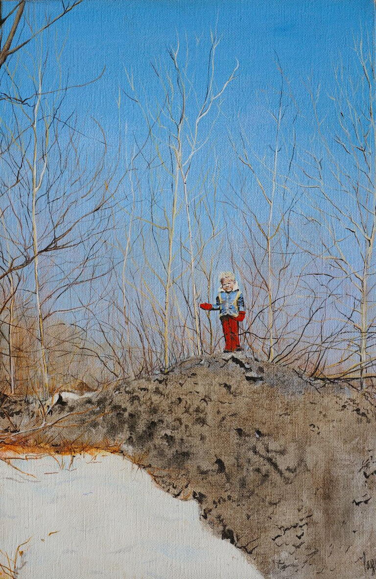 image of a blonde child standing on a rock with one of his arms outstretched