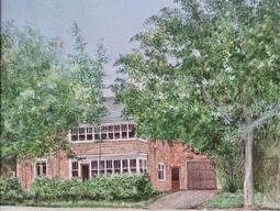image of brick house partially covered by green trees