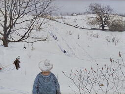 image of kids tobogganing down a snowy hill 