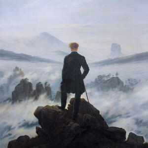 Man looking beyond on a cliff