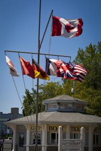 Canadian flag flying above a number of other national flags near the Kingston waterfront.