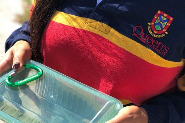Holding a GOOD TO GO container and Carabiner