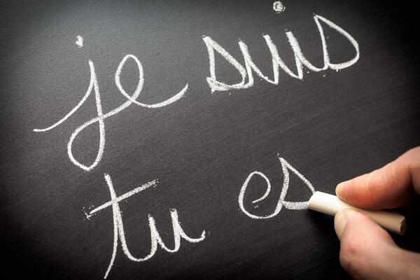 Conjugating verbs in French on a chalkboard