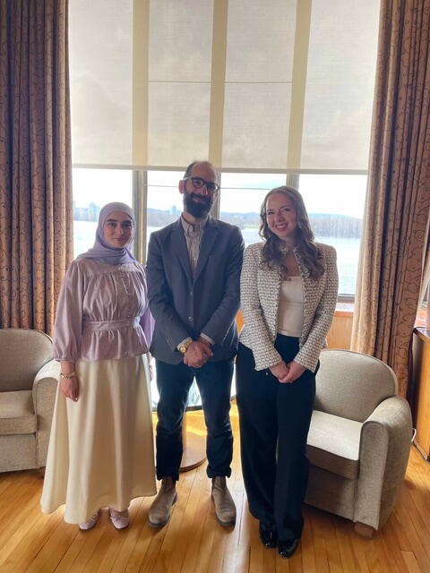 Professor Julien Lefort-Favreau stands with French Students from Queen's at the French Embassy in Ottawa.