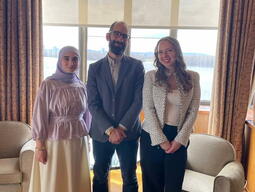 Professor Julien Lefort-Favreau stands with French Students from Queen's at the French Embassy in Ottawa.