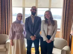 Professor Julien Lefort-Favreau stands with French Students from Queen's at the French Embassy in Ottawa.