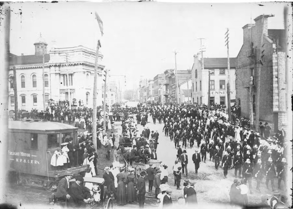 Military parade at the corner of Brock and Ontario Streets in Kingston, Ont. 1890. (Queen’s University Archives
