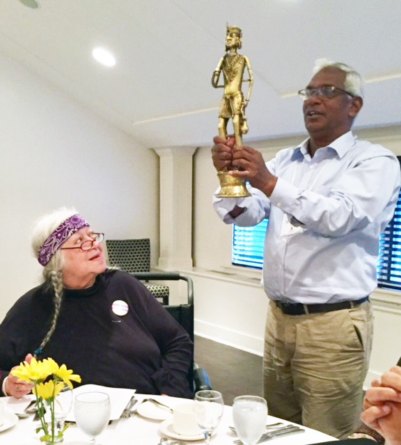 "Father Nicholas Barla holds a statue as Mohawk elder Laurel Claus-Johnson looks on during the opening dinner"