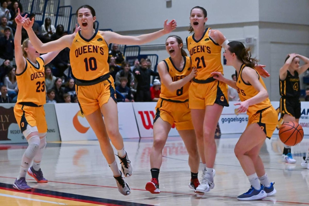 Members of the Queen's Gaels womens basketball team celebrate after beating the Waterloo Warriors.