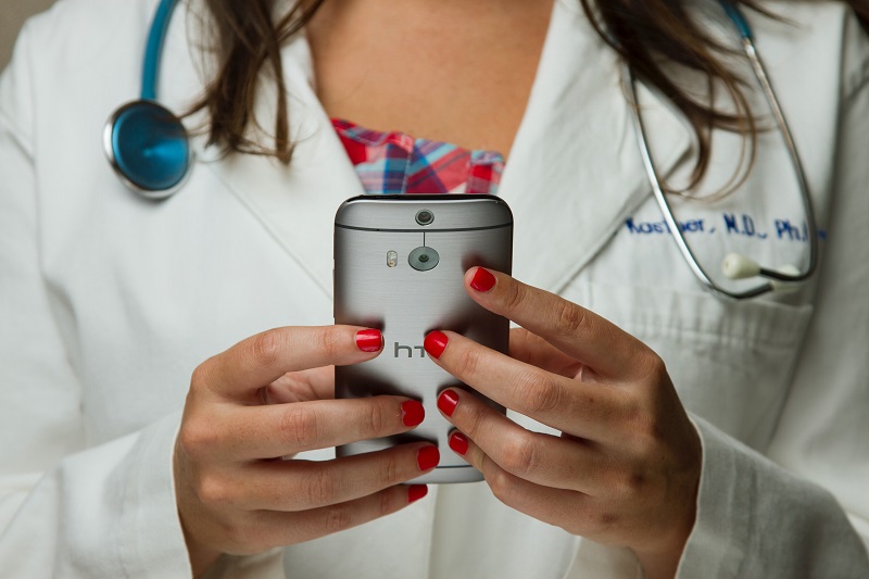 Female doctor works on a smartphone