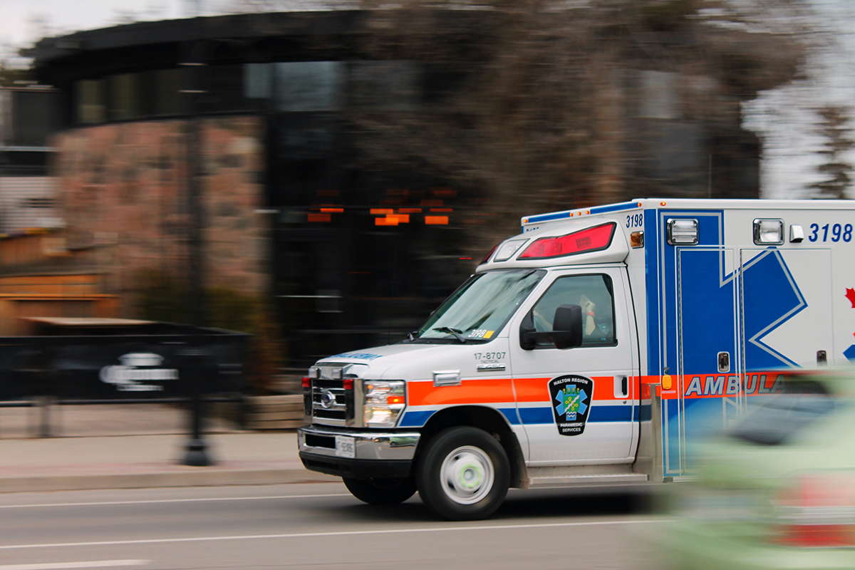 An ambulance speeds along a city street