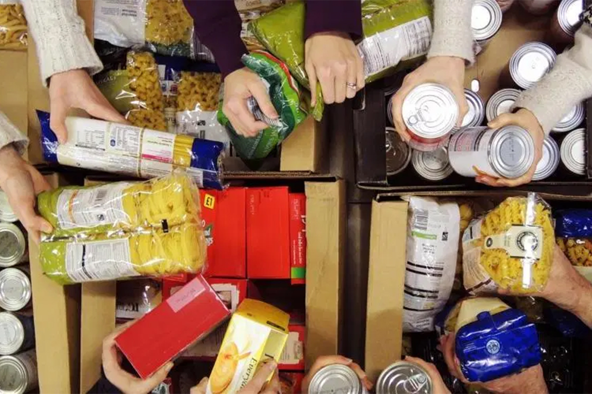 People pack boxes at a foodbank
