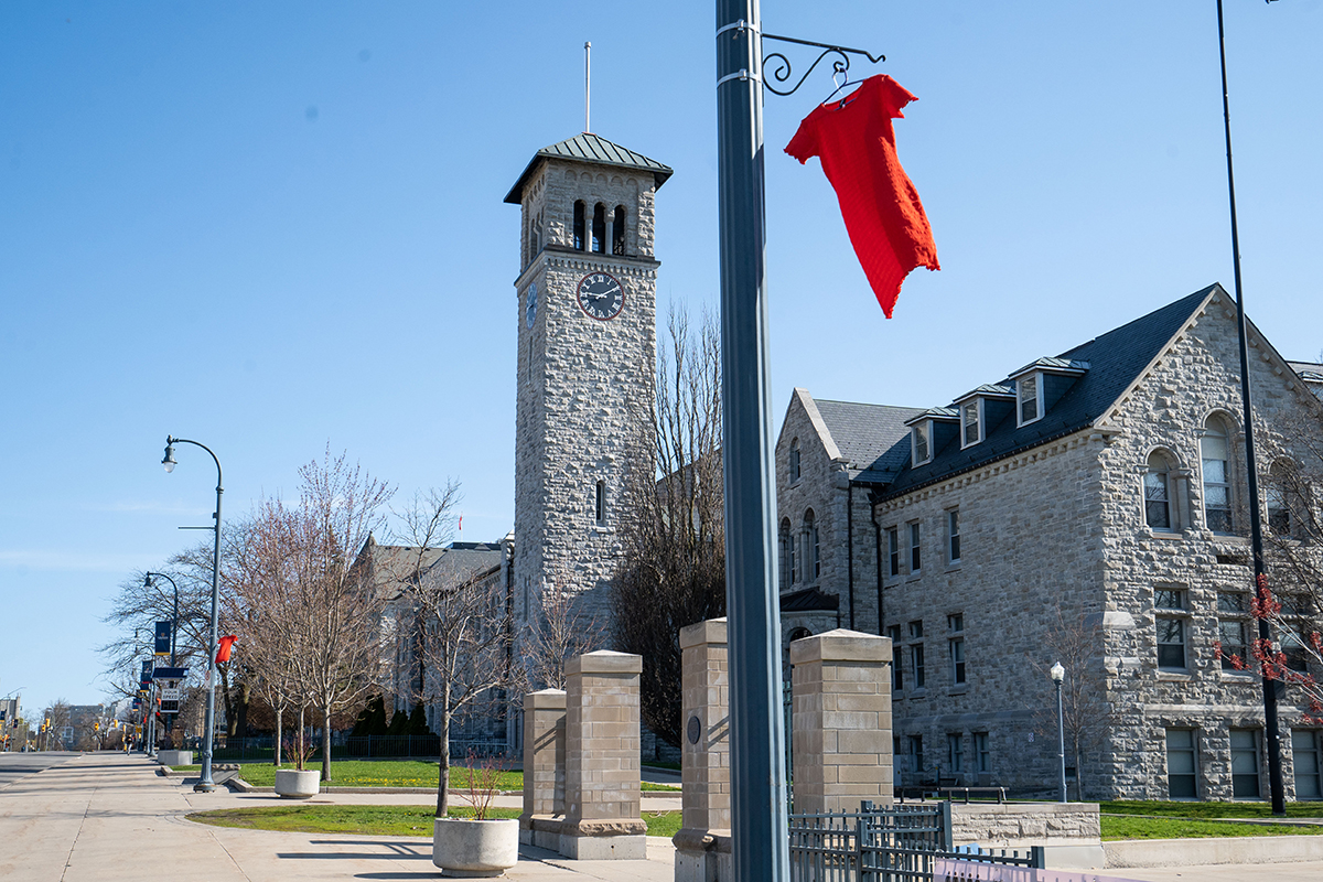 Red dresses adorn the light poles along University Avenue, with Grant Hall in the background.