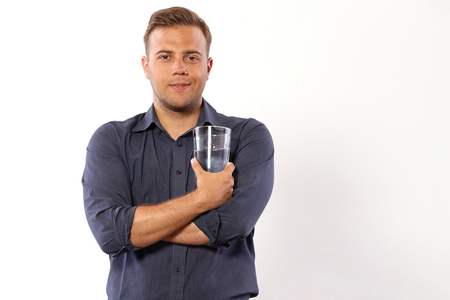 [photo of Matthias Hermann holding a glass of water]