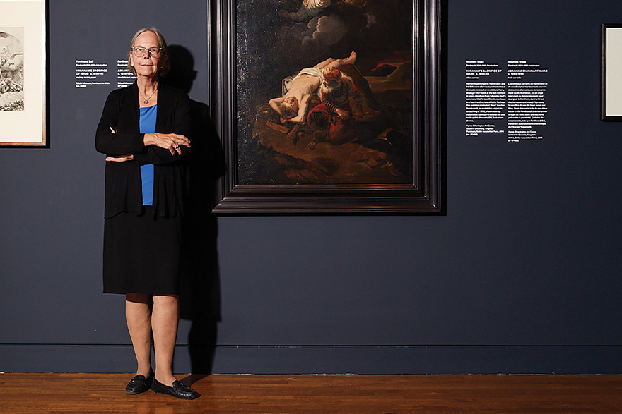A Rembrandt portrait hangs next to  Dr. Stephanie Dickey, Bader Chair in Northern Baroque Art.