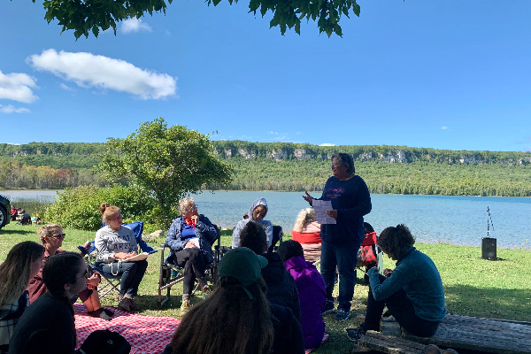 Sara Mainville—a lawyer at JFK Law LLP, a graduate of Queen’s Law, and a member of Couchiching First Nation in Treaty 3—speaks to participants on the topic “Written Guides to Live within Anishinaabe Inaakonigewin (Law).” 