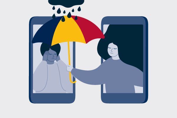 Mental Health Promotion Week - A woman holds an umbrella to protect another woman from rain