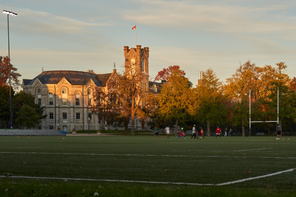 Theological Hall as seen across Nixon Field during sunset.
