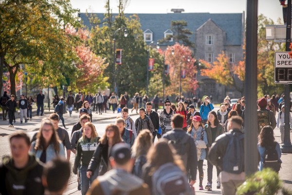 Photograph of students walking down University Avenue on Queen's campus.