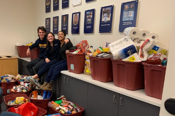 Photograph of members of the Varsity Leadership Council with donations.