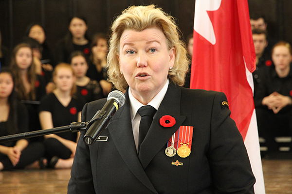Alice Aiken (School of Rehabilitation Therapy), Director, Canadian Institute for Military & Veteran Health Research (CIMVHR), speaks during the Remembrance Day ceremony.