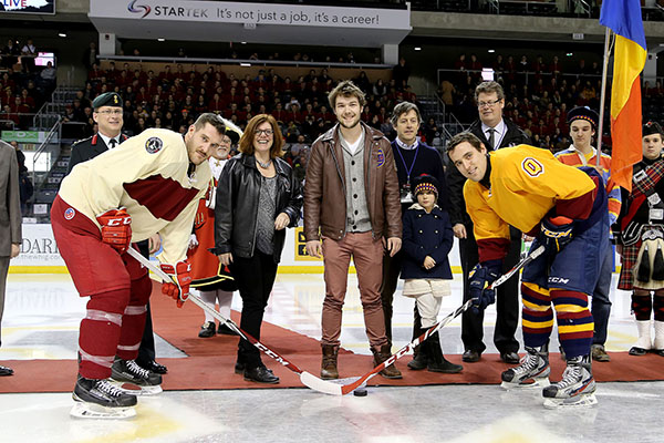 Sam Roe (Artsci'19), a Queen's student who helped rescue a woman from Lake Ontario on Feb. 3, drops the puck for the opening faceoff of the Carr-Harris Cup.