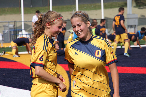 Jenny Wolever and Brittany Almeida confer before a corner kick during Sunday's match between the Queen's Gaels and the Carleton Ravens at the revitalized Richardson Stadium.